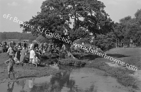 PILGRIM CROWDS ON BANKS OF STIFFKEY